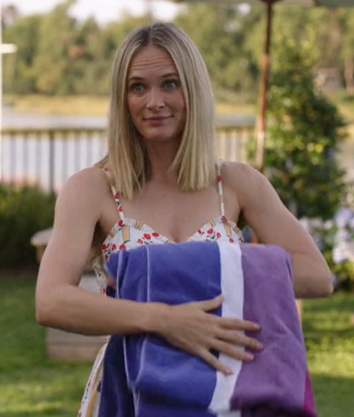 a woman holding a purple and white towel