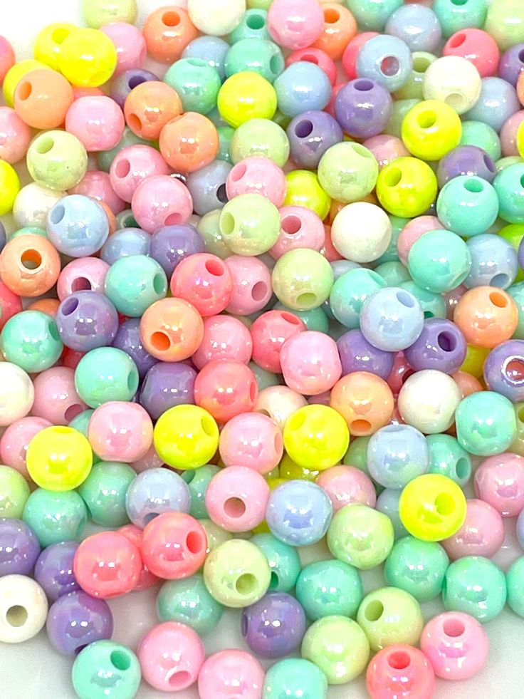 many different colored beads on a white surface