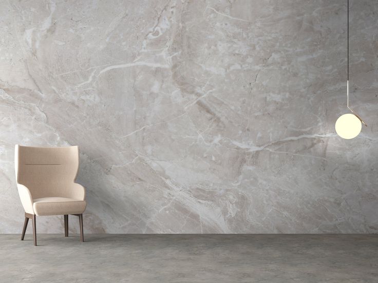 a white chair sitting in front of a marble wall