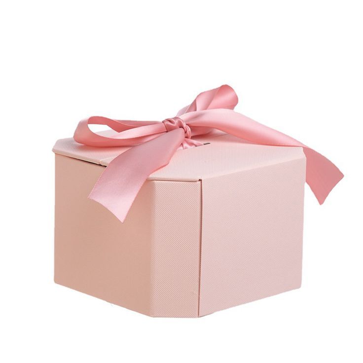 a pink gift box with a bow on top