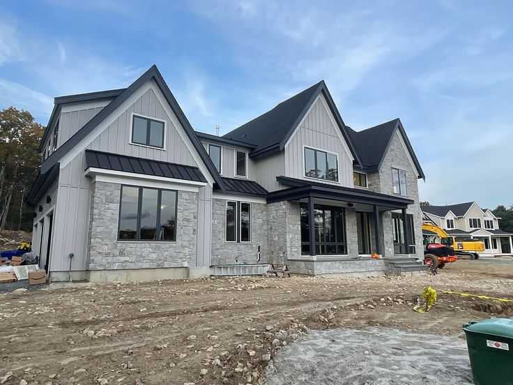 a house under construction in the process of being built with concrete and shingled siding