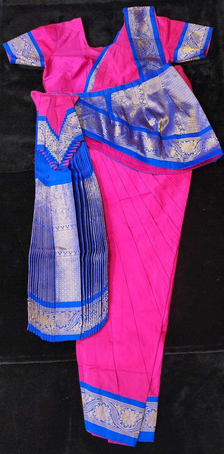 Readymade Bharatanatyam costumes Bring the beauty of Bharatnatyam to life with this ready-made dance costume. Crafted with high-quality fabrics, this costume will provide superior comfort and confidence while you perform. It's the perfect addition to any dancer's wardrobe. Material: Silk Cotton with Kanchipuram Border Size: 34/36/38/40 - Height from Waist to Ankle Bone Age: 14+ Years Cotton Silk Churidar For Ceremonial Festivals, Ceremonial Cotton Silk Churidar For Festivals, Traditional Pink Cotton Silk Churidar, Traditional Fitted Pre-draped Saree For Navratri, Ceremonial Cotton Silk Traditional Wear For Navratri, Traditional Pink Cotton Silk Choli, Traditional Blue Cotton Pre-draped Saree, Fitted Traditional Pre-draped Saree For Navratri, Traditional Fitted Multicolor Pre-draped Saree