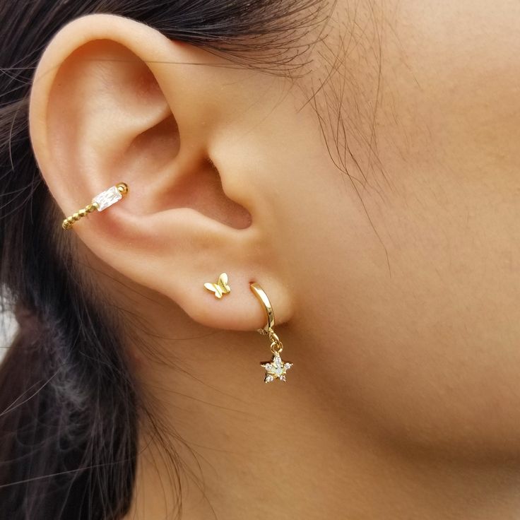 "An ode to the woman who chases her dreams, a twinkling star set with tiny opal and crystals dangle playfully from a mini hoop of 16k gold. ♥ Crafted in gold plated on the top of 925 sterling silver ♥ Diameter of hoops: outer - 11.5 mm / inner - 8.5 mm ♥ Measurement of star pendants: 6.5 mm tall and width ♥ Sold as a pair ♥ Nickel free ♥ All items are packed inside an elegant Gold Spoon jewelry box. If you are purchasing a product to send as a gift, we can send the product directly to the recipi Dainty Star Charm Earrings, Dangle Earrings With Star Charm, Dainty Gold Earrings, Gold Spoon, Gold Ear Cuff, Spoon Jewelry, Gold Dangle Earrings, Dainty Studs, Tiny Star