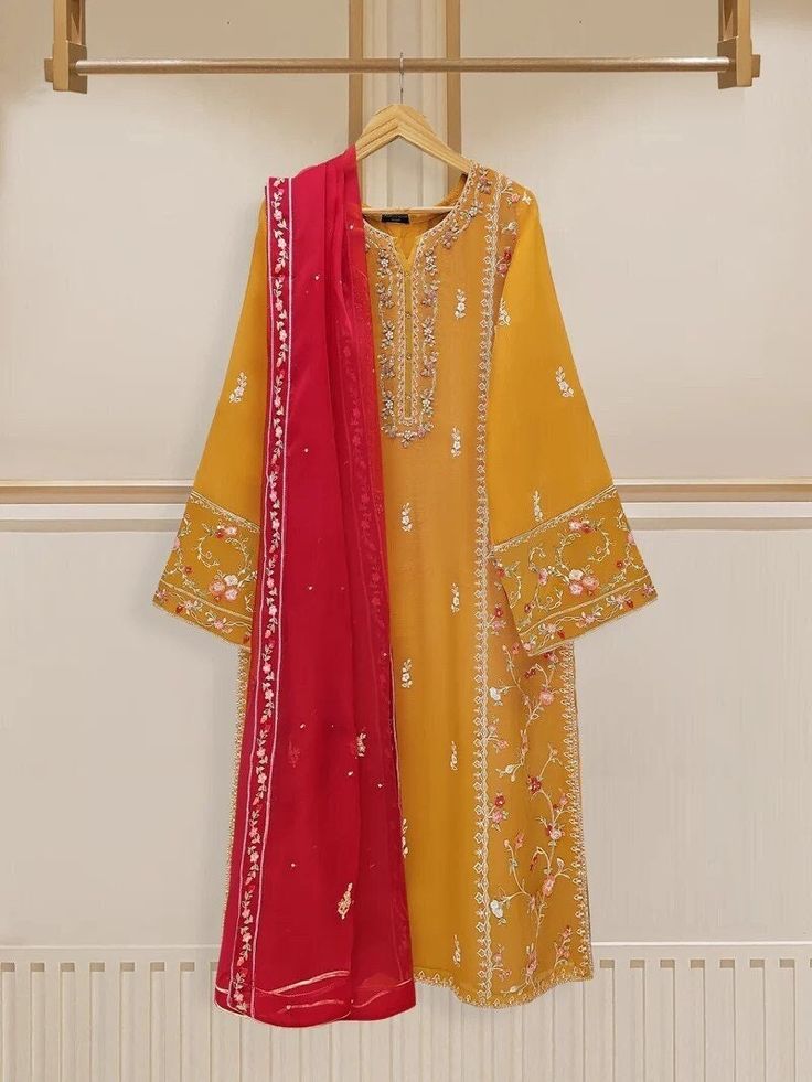 Elegant embroidered cotton net shirt with pants and dupatta a perfect choice for those who appreciate intricate detailing and graceful style. Crafted from high-quality cotton net fabric, this shirt offers a lightweight and luxurious feel, allowing you to feel comfortable and chic throughout the day. The set comes with a matching dupatta and pant which enhances the overall look and adds a touch of finesse to your outfit. Length: 45" Pants Fabric : Raw Silk Dupatta Fabric : Organza Festive Churidar With Resham Embroidery In Cambric, Traditional Salwar Kameez With Naqshi Detailing, Festive Resham Embroidered Churidar In Cambric, Red Sharara With Naqshi For Eid, Festive Resham Embroidery Cambric Churidar, Traditional Unstitched Suit In Chinon With Naqshi, Traditional Unstitched Suit With Naqshi In Chinon, Festive Shantoon Anarkali Set With Naqshi Detailing, Festive Shantoon Anarkali Set With Naqshi