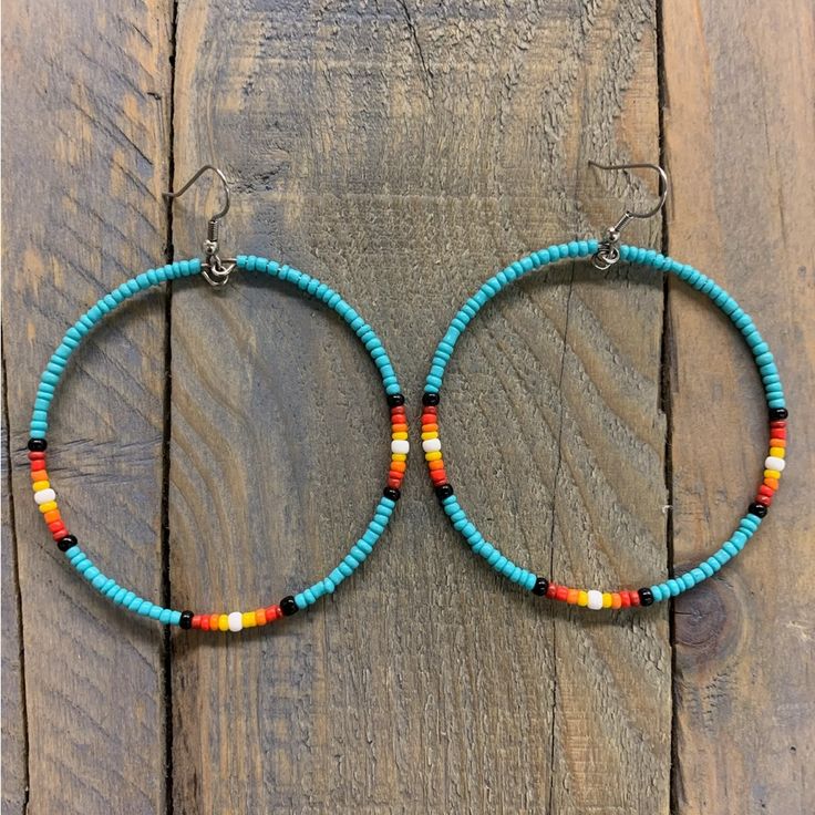 the hoop earrings are made with turquoise and orange beads