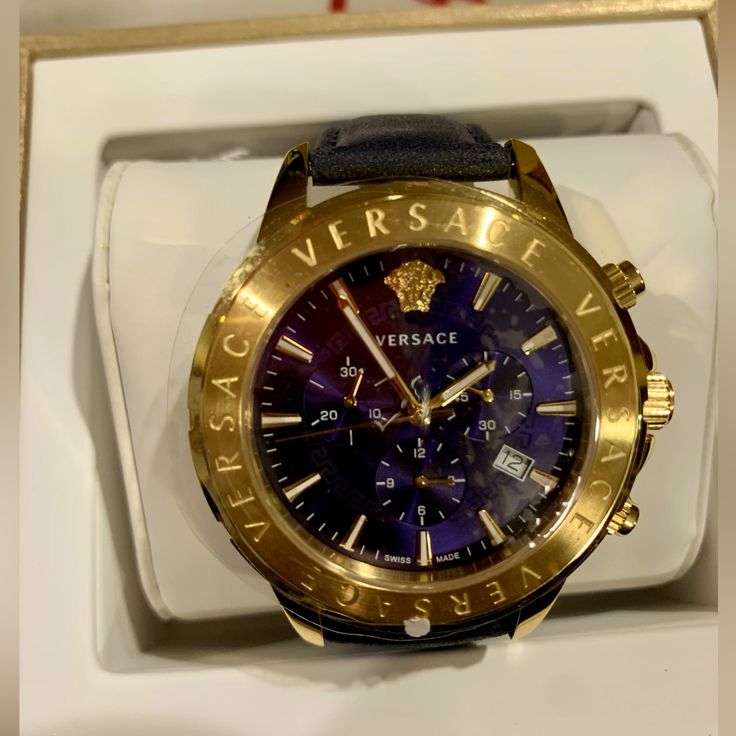 Just Reduced By $200! Luxurious Ip Gold Plated With Chronograph, Navy Blue Face, Navy Blue Leather Strap, Luminous Blue Side Buttons, Sapphire Crystal, Date Window And Water Resistant 50m. Versace Engraved Around The Bezel, Engraved Inside Leather Strap. New In Box W/ Protective Plastic Still On Case. Guaranteed Authentic. Luxury Leather Watch With Skeleton Dial, Designer Leather Watch With Metal Dial, Designer Formal Chronograph Watch With Metal Dial, Designer Chronograph Watch With Metal Dial For Formal Events, Designer Chronograph Watch With Metal Dial For Formal Occasions, Gold Chronograph Watch With Metal Dial And Leather Strap, Luxury Chronograph Watch With Skeleton Dial, Luxury Leather Chronograph Watch With Round Dial, Luxury Leather Chronograph Watch With Tachymeter