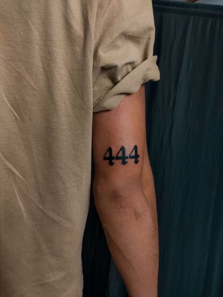 a man with a tattoo on his arm that has the number forty four in it