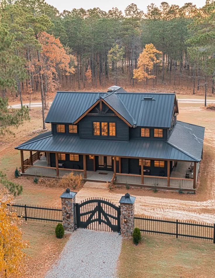 an aerial view of a large home in the woods