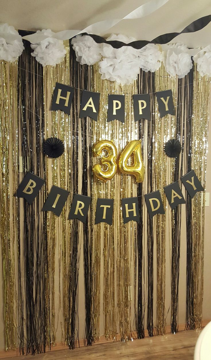 an image of a happy birthday party with balloons and streamers on the wall in front of it