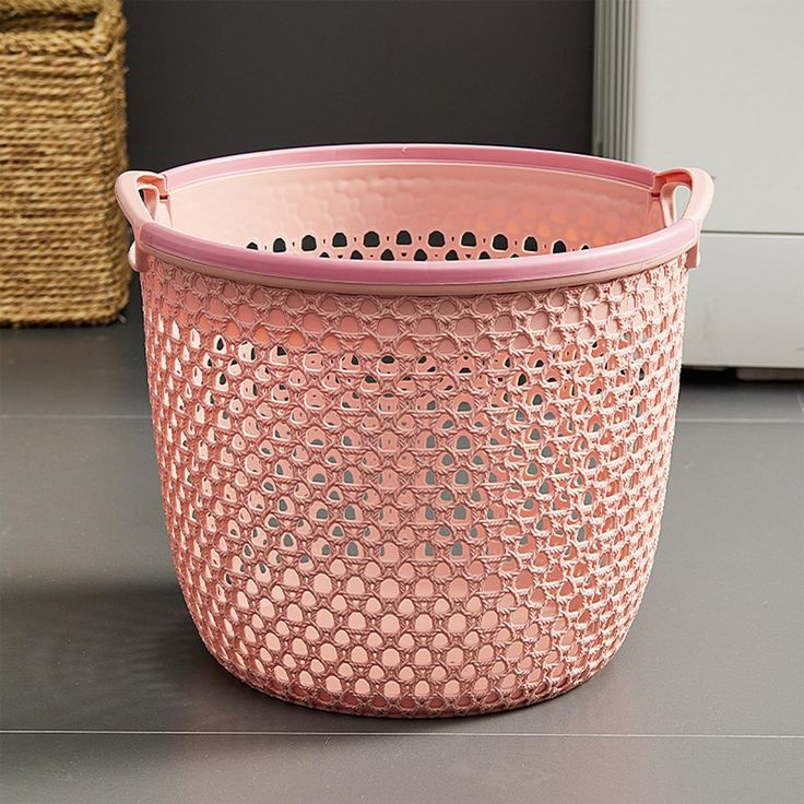 a pink basket sitting on top of a table