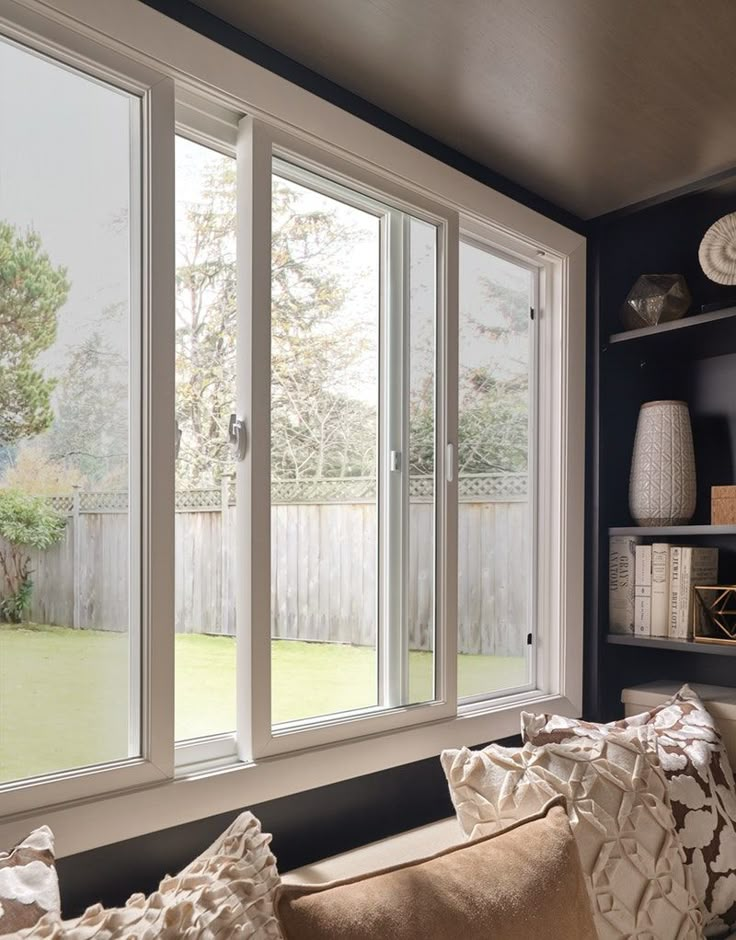 a living room filled with furniture next to a sliding glass door that opens onto a back yard