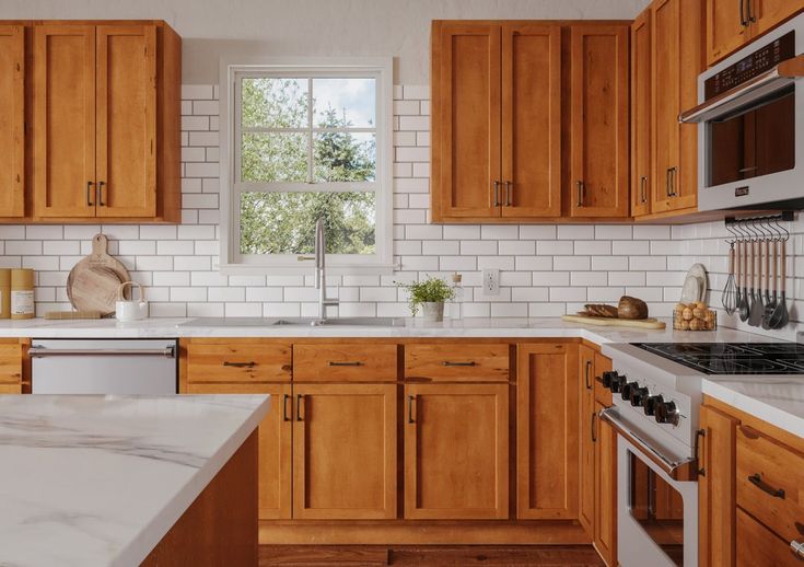 a kitchen with wooden cabinets and white marble counter tops, an oven, microwave and dishwasher