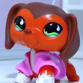 an orange and pink toy dog with big eyes