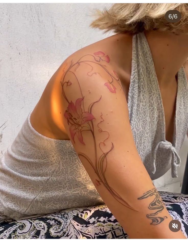 a woman with a flower tattoo on her arm