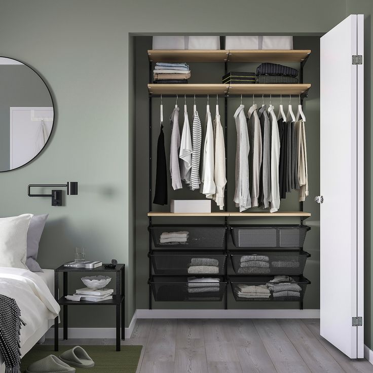 an organized closet with clothes hanging on the shelves and shoes sitting on the floor next to it