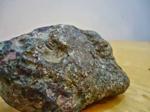 a rock sitting on top of a wooden table