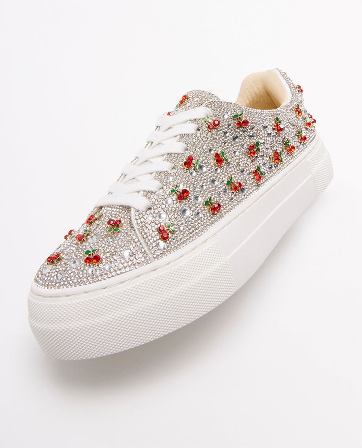 Put a little sparkle in your step with the SIDNY all-over rhinestone platform sneakers. These sparkly cherry embellished sneakers can be paired with your best dress or favorite jeans, offering a combination of glamour and stylish comfort. The SIDNY rhinestone shoe is available in a variety of captivating colors and prints to make any look a little more luxurious! Manmade upper materials with rhinestones and charms Lace-up closure Textile lining with cushioned insole Textured rubber outsole 1.5" inch platform 45.27” inch total shoe-lace length Recommended to clean with a dry cloth Imported Sneaker Charms, Embellished Sneakers, Rhinestone Shoes, Best Dress, Shoe Lace, Spring Trends, Platform Sneakers, Shoe Box, Favorite Jeans