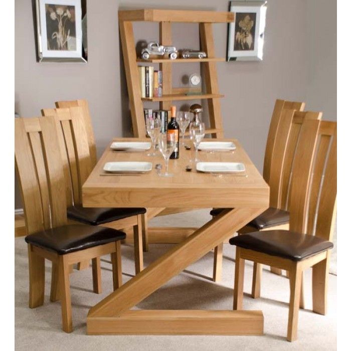 a wooden table with chairs and plates on it