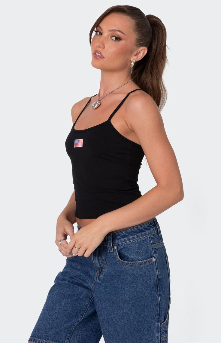 Online only! Feel like the ultimate American babe in this cute Edikted USA Tank Top. Pair this tank with any bottoms you like for the coolest effortless look. 


	Tank top
	Adjustable straps
	Embroidered patch
	Cotton, Spandex
	Model wears size S
	Model height is 5'8
	Item care: Machine wash at maximum 30C, do not bleach, tumble dry low, iron at a maximum of 110C, do not dry clean. Black Casual Tank Top With Straps, Casual Black Tops With Tank Straps, Casual Black Top With Tank Straps, Casual Everyday Tops With Straps, Casual Tops With Adjustable Straps For Everyday, Black Casual Cami Tank Top, Casual Black Camisole With Tank Straps, Trendy Cotton Cami Tank Top, Casual Crop Tank Top With Built-in Bra