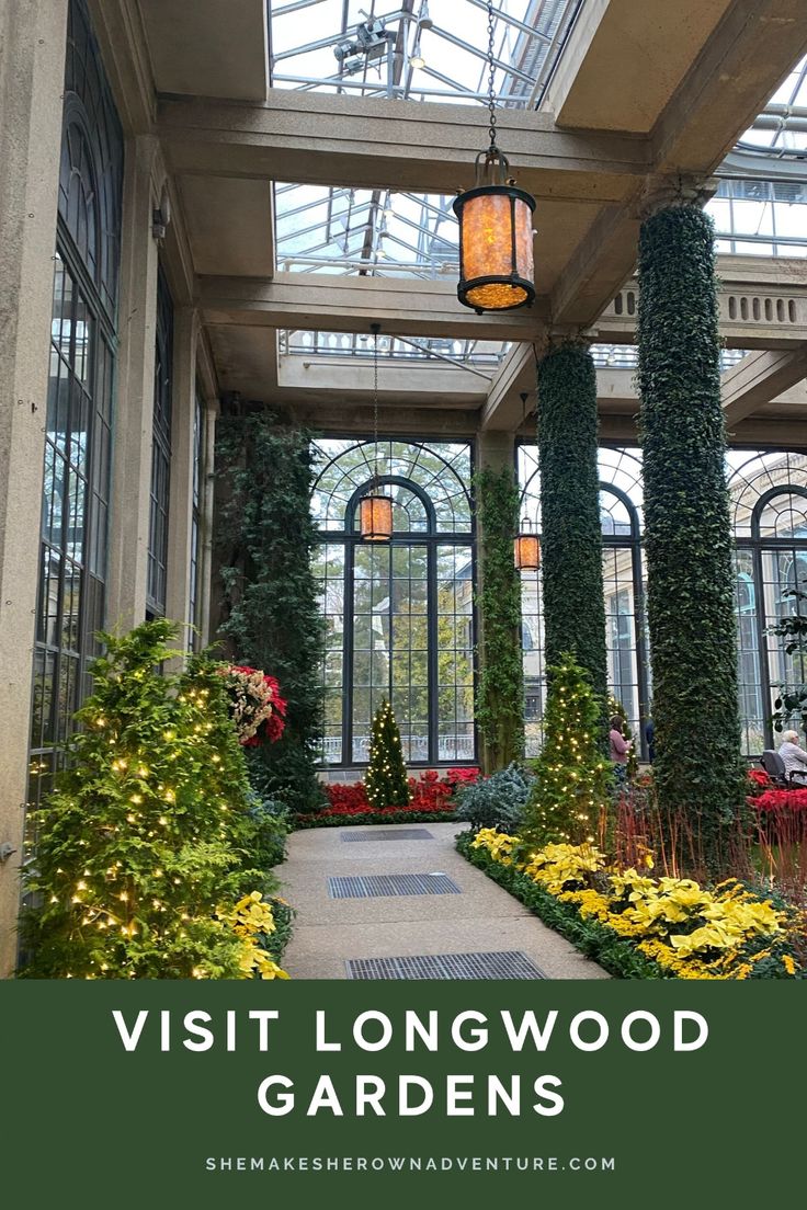 the inside of a building with lots of plants and flowers in it, along with text overlay that reads visit longwood gardens