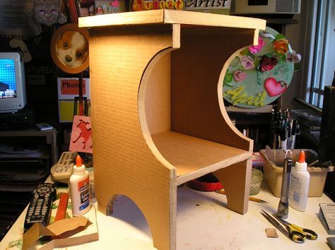 a desk with some crafting supplies on it and a computer monitor in the background