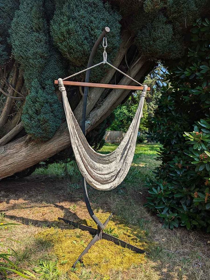 a hammock hanging from a tree in a yard