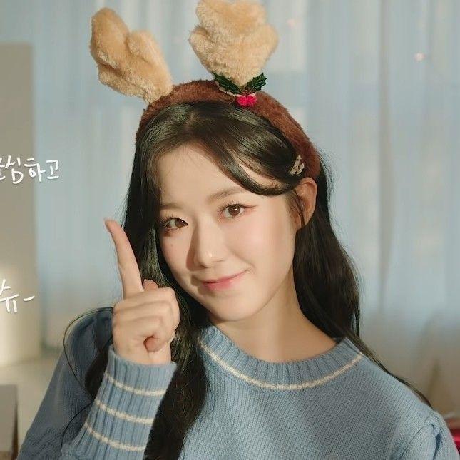 a girl with long black hair and bunny ears on her head giving the peace sign