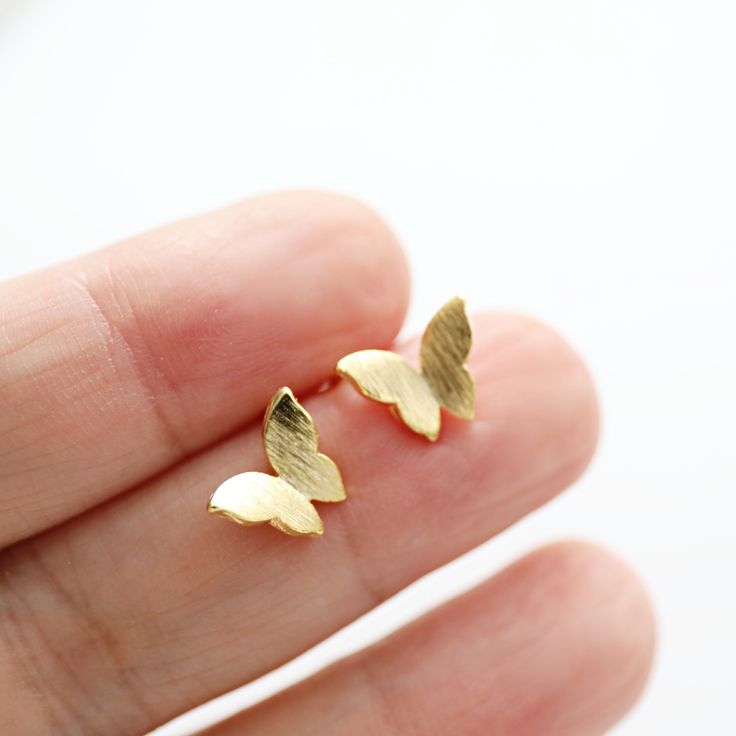 Beautiful and lovely tiny gold butterfly stud earrings. The post material is 925 silver post and the butterfly is gold-plated brass. Your earrings will ship in a gift box.    ♥ Earring size approx. 3/8" ♥Post Material  925 silver post ♥ 14K Gold Plated ♥ 1 Pair ♥ Delivery Time Fast shipping within 1 - 3 days  ♥  See more Rudiana Accessories  Rudiana.etsy.com Gold Earrings With Butterfly Charm For Anniversary, Gold Plated Butterfly Earrings As Gift, Dainty Butterfly Earrings For Anniversary, Tiny Dainty Butterfly Earrings, Dainty Tiny Butterfly Earrings, Tiny Butterfly Dainty Earrings, Delicate Gold Earrings With Butterfly Charm, Gold Butterfly Earrings For Gift, Delicate Butterfly Earrings Gift