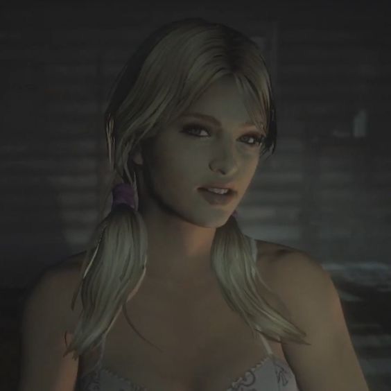 a woman with long blonde hair wearing a bra and looking at the camera while standing in a dimly lit room