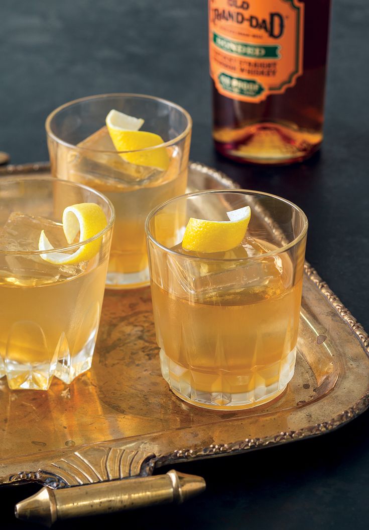 two glasses filled with lemonade sitting on top of a tray