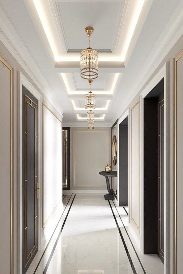 an empty hallway with chandelier and marble flooring is seen in this image