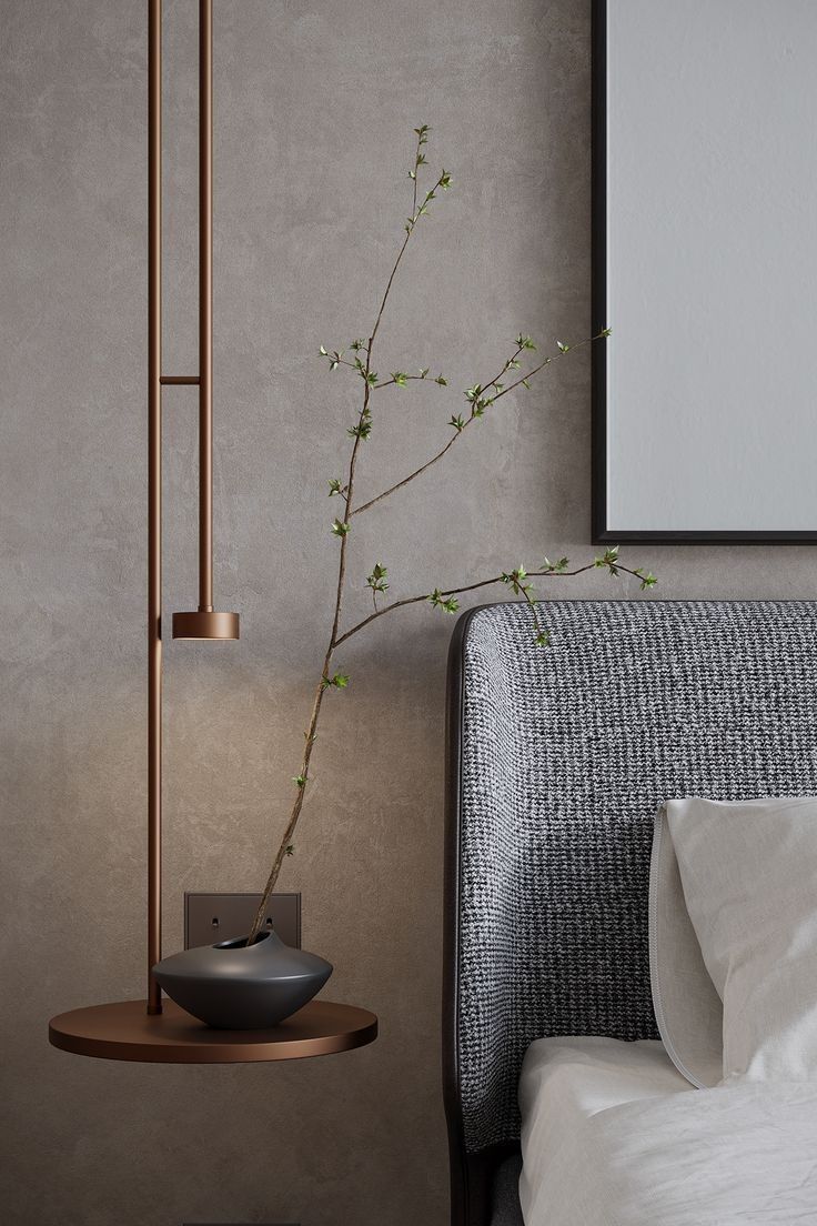 a bedroom with a bed and a plant in the corner next to it on a table