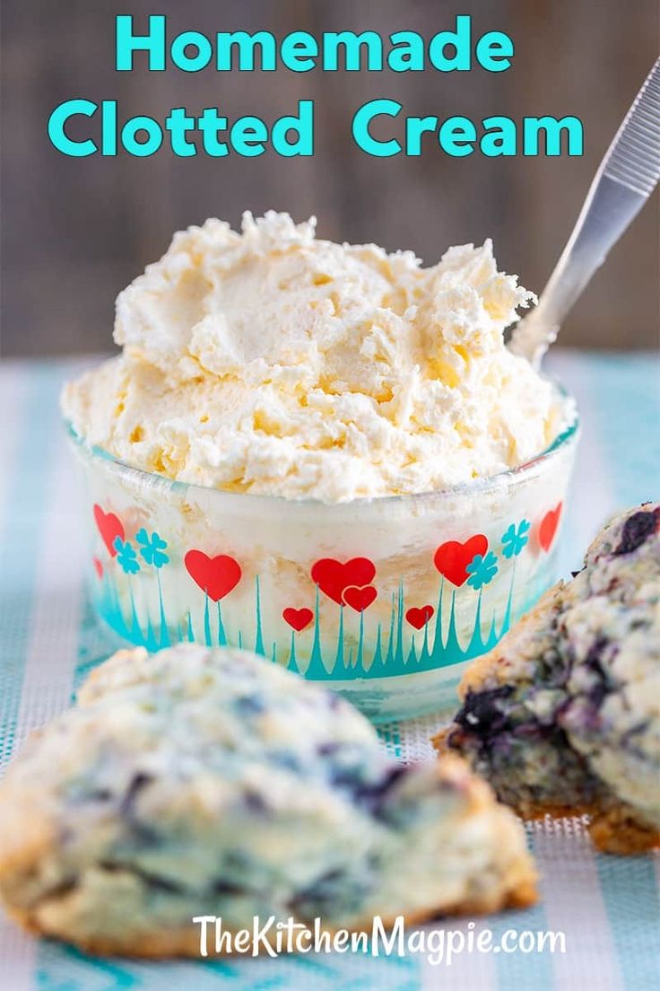 a bowl filled with whipped cream next to muffins on a blue and white checkered table cloth