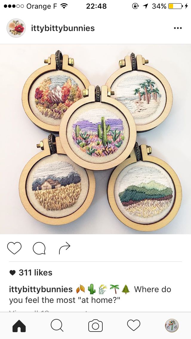 four cross stitch coasters with cactus designs on them, each one has an embroidered desert scene