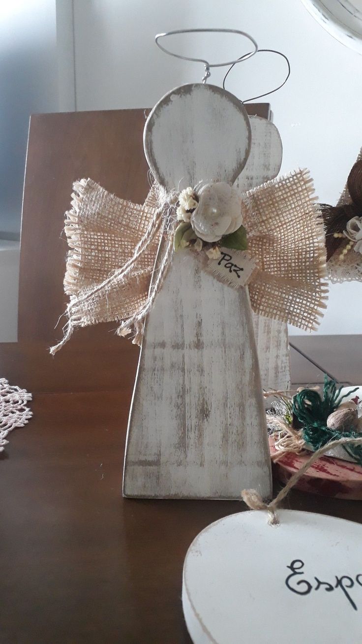 a wooden angel sitting on top of a table