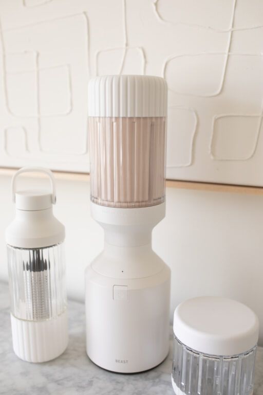 two jars and one container are sitting on the counter