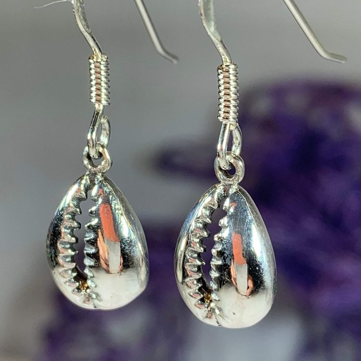 TAKE AN ADDITIONAL 20% OFF THE ALREADY REDUCED SALE PRICE - ADDITIONAL 20% IS DEDUCTED AT CHECKOUT Solid sterling silver The Goddess rises from the sea foam when a shell is tossed into the surf - this seashell symbolizes the beauty of woman and of the sea. This tiny Cowry (also spelled Cowrie) shell symbolizes the giver of life - woman and the gifts of fertility and abundance. A beautiful piece for any one who loves nature and power of a woman. 1/2" x 1/4" earrings in solid sterling silver with Handmade Silver Shell For Beach, Silver Shell-shaped Pendant With Lobster Clasp, Silver Ocean-inspired Earrings For Gifts, Adjustable Silver Shell-shaped Jewelry, Handmade Silver Shell Drop Earrings, Handmade Silver Dangle Shell, Silver Shell-shaped Earrings, Adjustable Silver Shell-shaped Earrings, Silver Teardrop Earrings For Beach