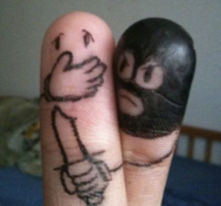 two fingers with faces drawn on them, one is holding the other's hand