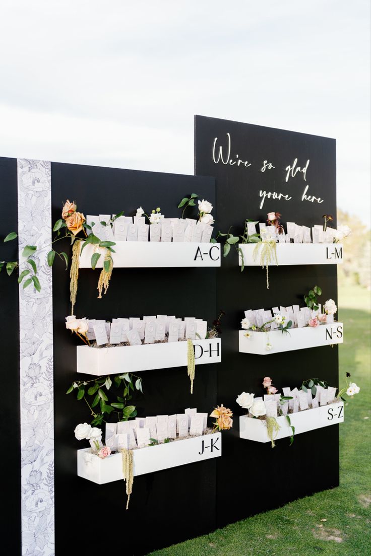 a black and white wall with flowers on it