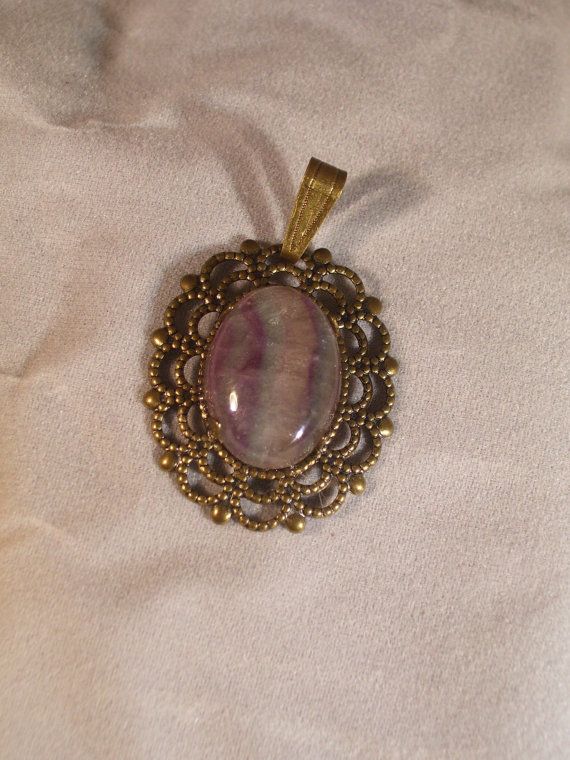 Flourite Cab in BronzePendant by CabochonsByBev on Etsy Vintage Gemstone Cabochons For Gifts, Handmade Oval Cabochons For Gifts, Antique Gold Soldered Pendant Jewelry, Antique Cabochon Round Pendant Jewelry, Antique Gold Soldered Round Pendant Jewelry, Antique Gold Jewelry With Soldered Round Pendant, Brass Oval Pendant With Cabochon, Artisan Oval Brass Jewelry, Brass Cabochon Oval Pendant Jewelry