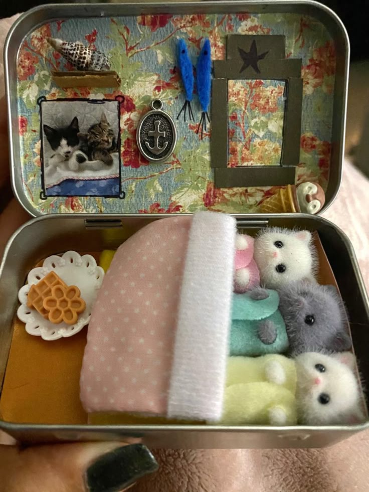 an open tin can with stuffed animals in it