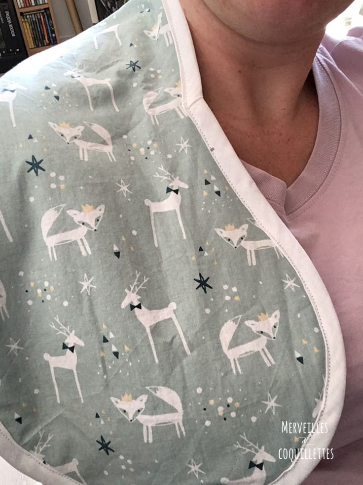 a woman wearing a bib with deers on it and stars in the sky