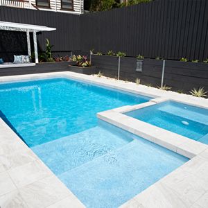 an empty swimming pool in the middle of a backyard