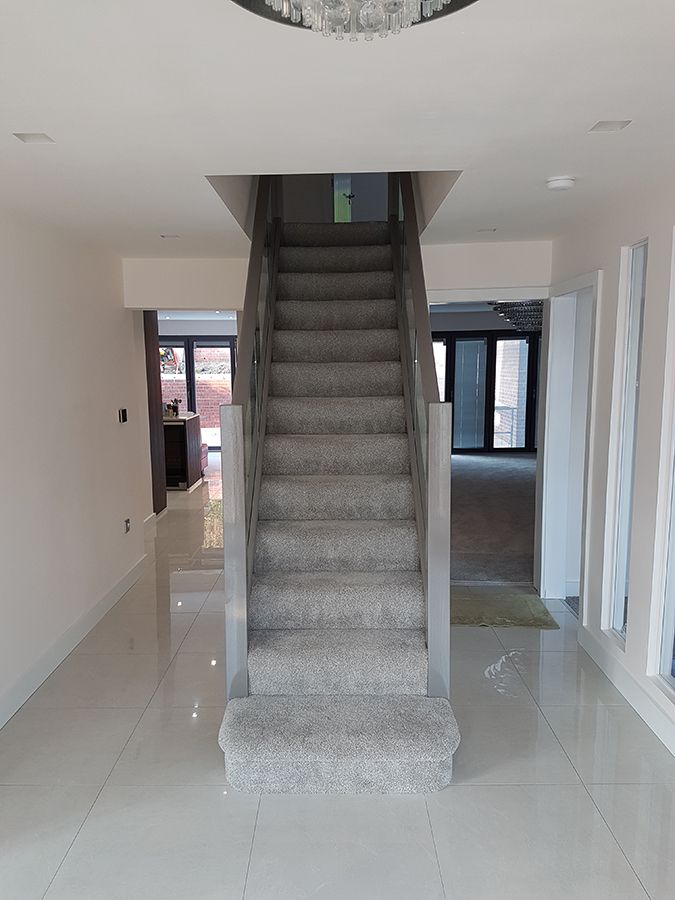 an empty room with stairs leading up to the second floor