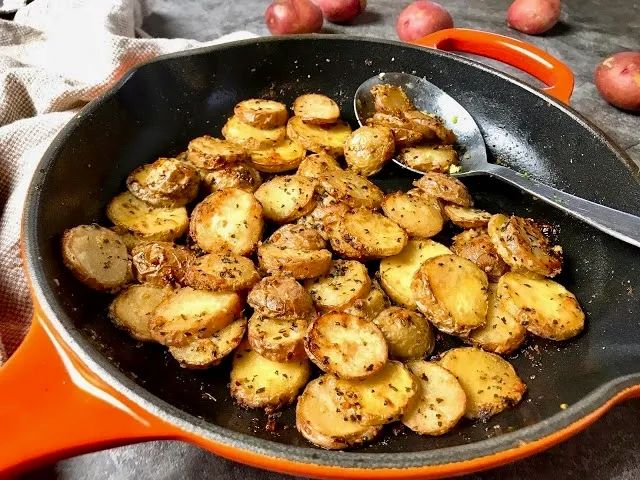 a pan filled with potatoes on top of a table