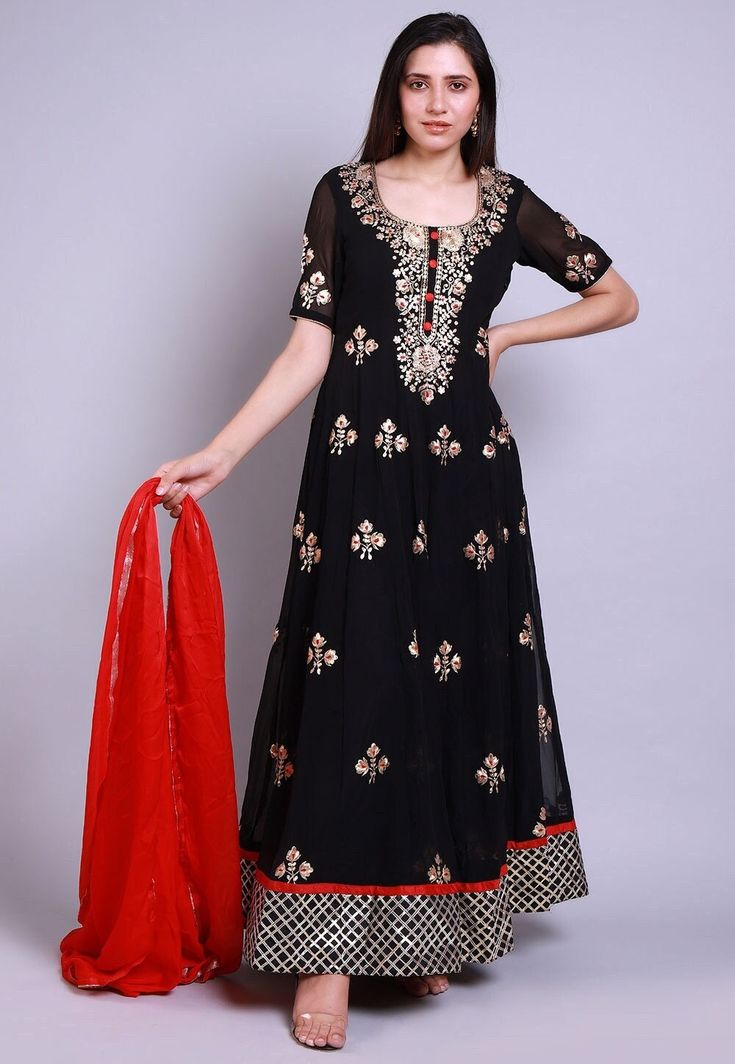 Faux Georgette Abaya Style Kameez in Black. This Readymade attire with Shantoon Lining is Enhanced with Buttons, Resham, Zari, Pita and Patch Border Work and is Crafted in Square Neck and Half Sleeve.Available with a Lycra Leggings in Black and a Faux Chiffon Dupatta in Red. For sizes 46 to 66, a Churidar will be available instead of the leggings. The Kameez and Bottom Lengths are 55 and 45 inches respectivelyDo note: Accessories shown in the image are for presentation purposes only and length m Semi-stitched Black Churidar With Self Design, Black Anarkali Set With Straight Kurta, Black Palazzo Set With Sheer Dupatta, Black Georgette Sharara With Dabka Work, Black Transitional Anarkali Set With Traditional Drape, Black Anarkali Set For Festive Occasions, Black Resham Embroidered Festive Anarkali Set, Semi-stitched Black Dress With Dabka, Black Floor-length Salwar Kameez With Dabka Detail