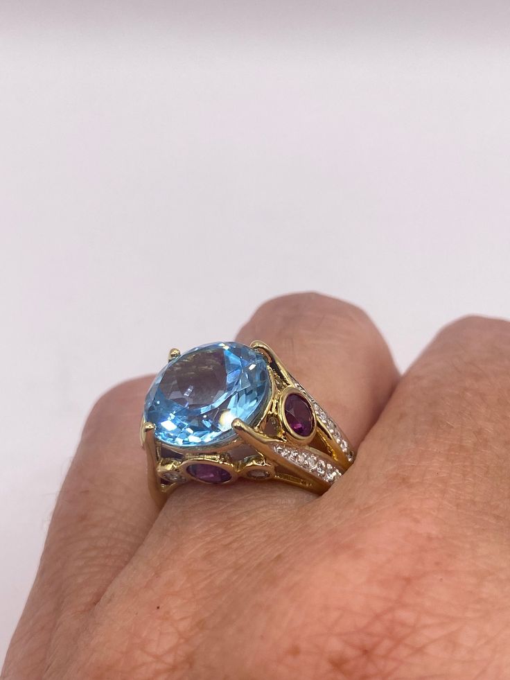 Vintage cocktail ring. Huge great color blue topaz stone  surrounding  setting is handcrafted in 925 sterling silver  Size  6.5 Can be sized, my jeweler charges $20  All rings are shipped free in the US in a nice gift box.   Check out our over a THOUSAND great reviews Engraving is $4 per letter and is not always perfect depending on the piece. It can take a few days if the jeweler is busy. This is payable to Paypal Judithsltd@gmail.com  PLEASE NOTE If we have multiples of the same vintage item, Luxury Birthstone Ring With Gemstone Accents, Fine Jewelry Multi-stone Blue Topaz Ring, Unique Multi-stone Blue Topaz Ring, Sapphire Color Multi-stone Topaz Ring, Luxury Blue Amethyst Ring, Round Aquamarine Multi-stone Topaz Ring, Luxury Round Topaz Gemstone Ring, Unique Blue Topaz Ring For Formal Occasions, Elegant Blue Multi-stone Amethyst Ring