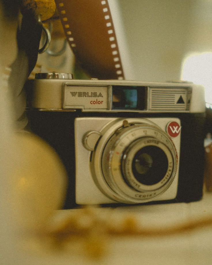 an old camera sitting on top of a table