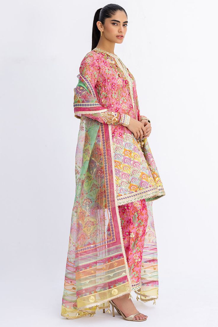 This short, aurora pink angarkha is the embodiment of a classy yet charming festive look. It is rendered with a thoughtful arrangement of zardoze and gota work on a floral-printed khaddi silk, featuring a chatapatti border. A multi-coloured dupatta with gota finishing and a printed shalwar add the final touches to this Gota Work, A Line Kurta, Desi Style, Festive Look, Website Features, Silk Organza, Wedding Outfits, Pakistani Outfits, Punjabi Suits