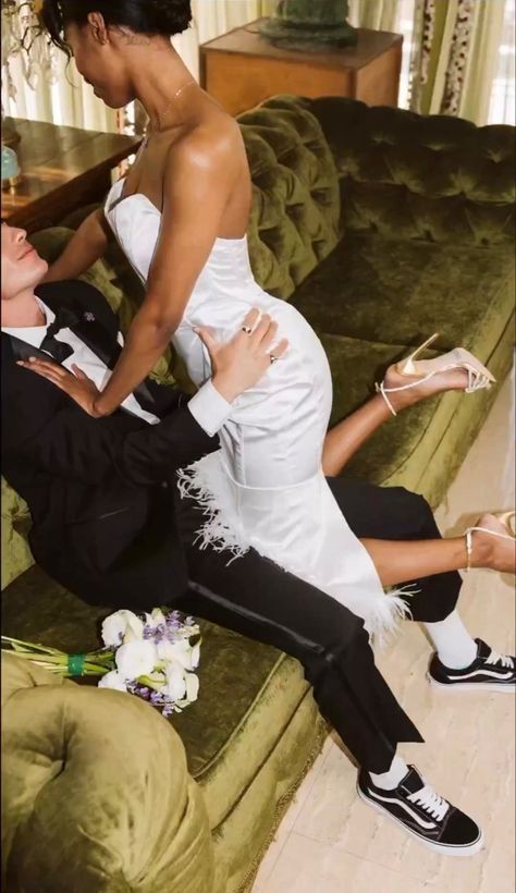 a man in a tuxedo is sitting next to a woman on a couch